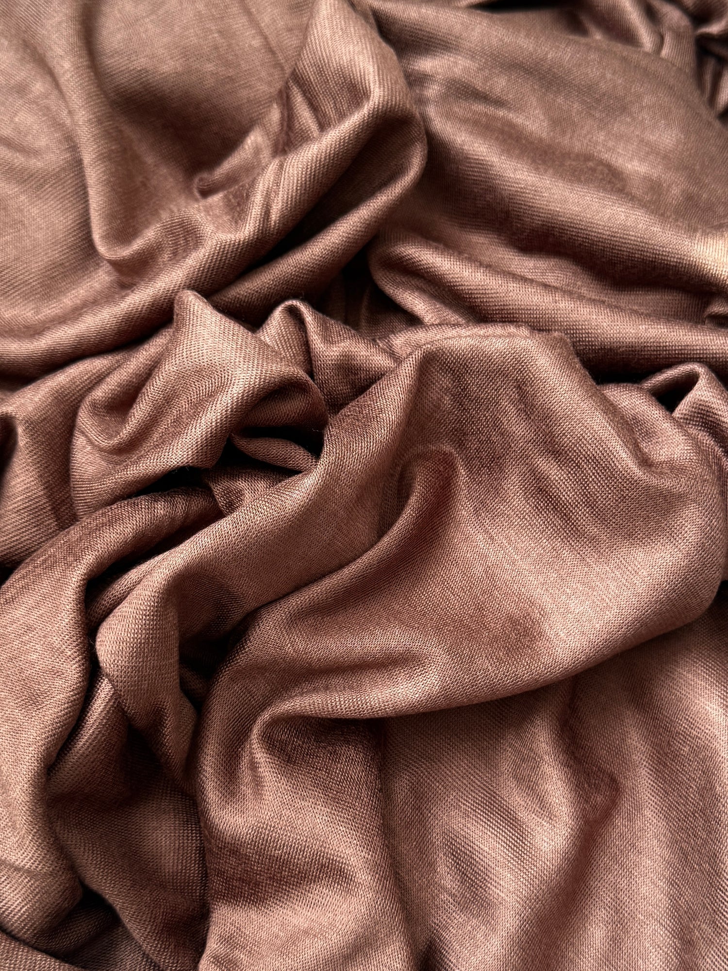 Close-up of soft jersey hijab fabric showing smooth texture and natural drape.