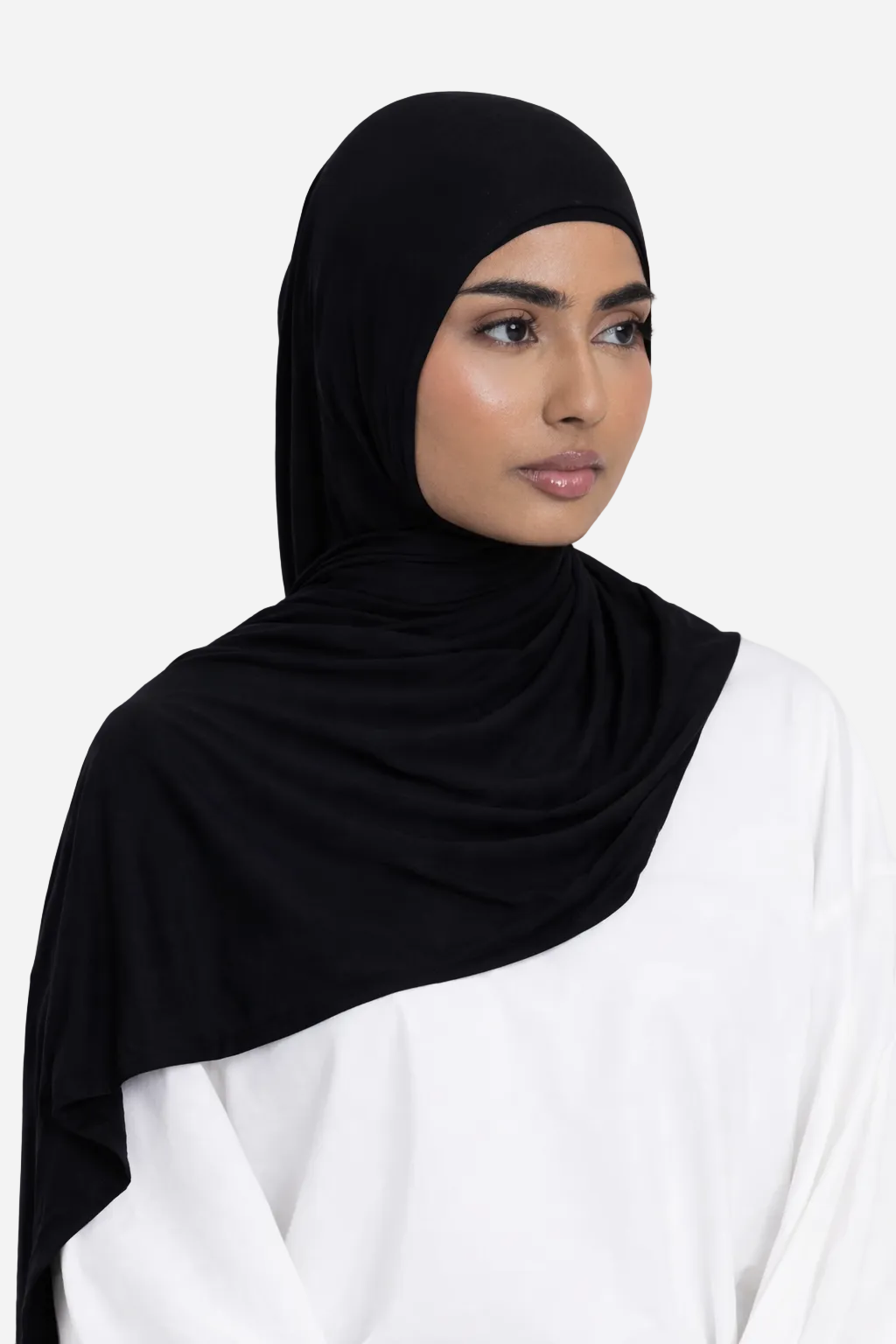Model wearing a black premium bamboo jersey hijab by Amanah, showing a smooth, secure, and elegant drape