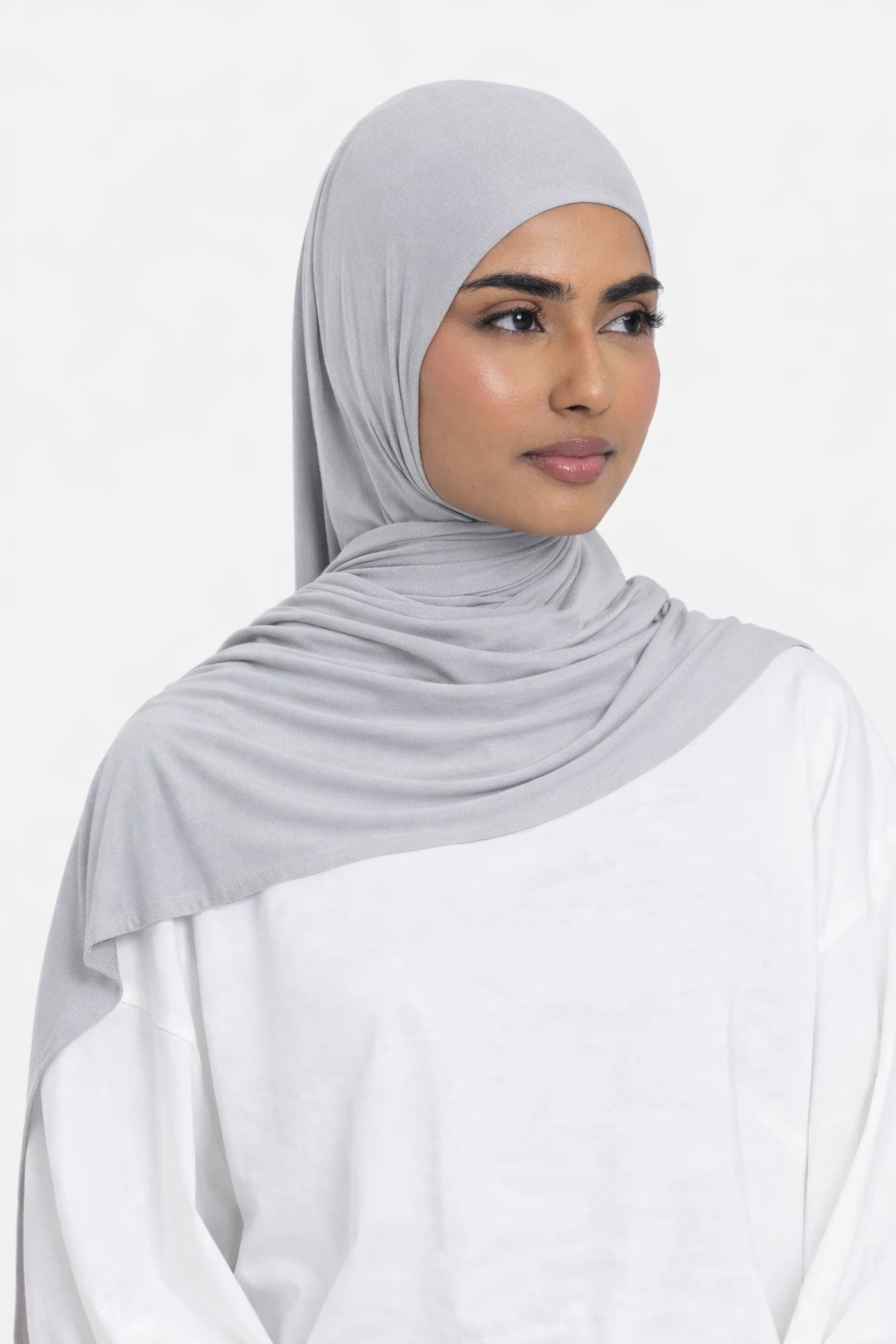 Model wearing a mist premium bamboo jersey hijab by Amanah, showing a smooth, secure, and elegant drape