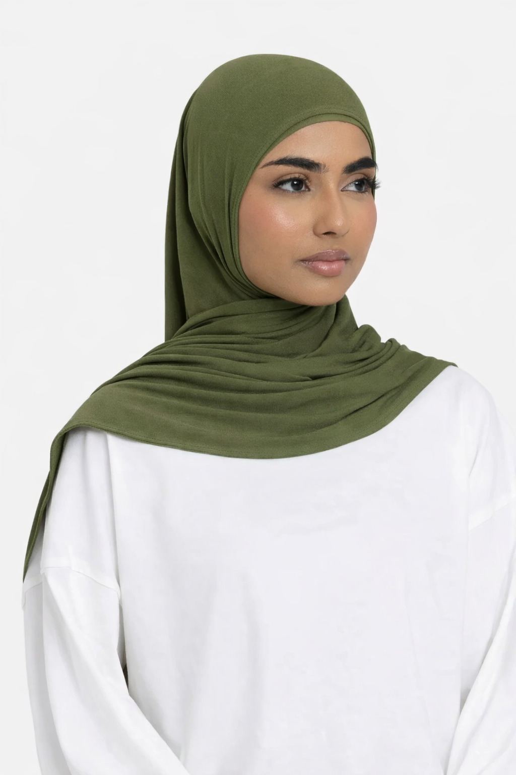 Model wearing a olive premium bamboo jersey hijab by Amanah, showing a smooth, secure, and elegant drape