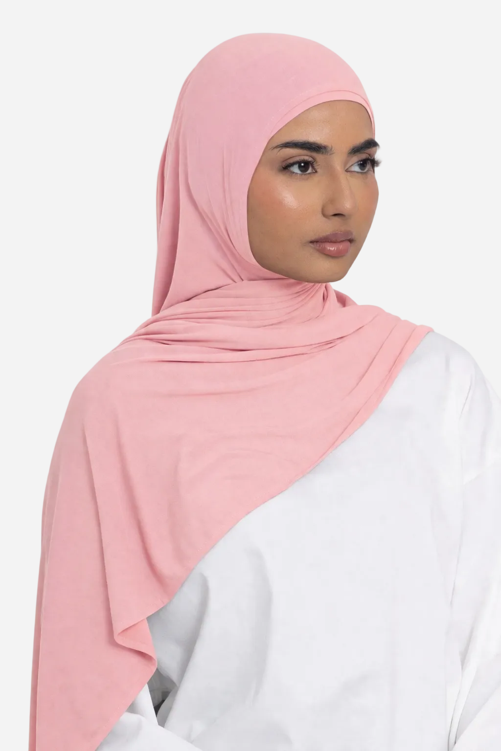 Woman wearing a rose premium bamboo jersey hijab by Amanah styled smoothly over a white outfit
